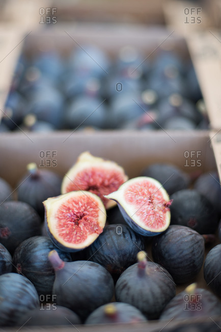 Split fig on box of fresh figs for sale at market