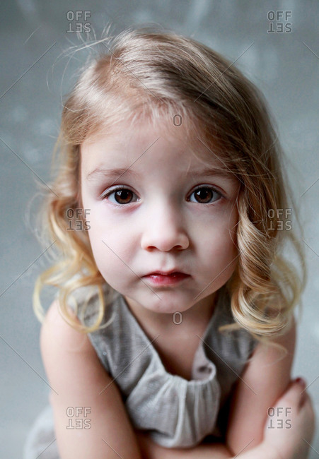 Girl with brown eyes and wavy hair stock photo - OFFSET