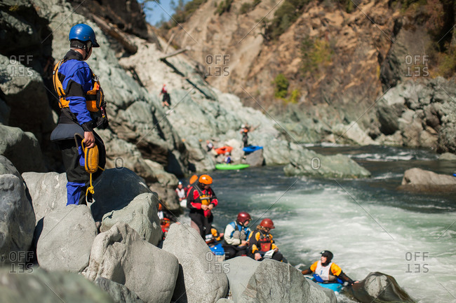 Whitewater kayakers on the side of the Trinity River in Burnt Ranch Gorge in northern California