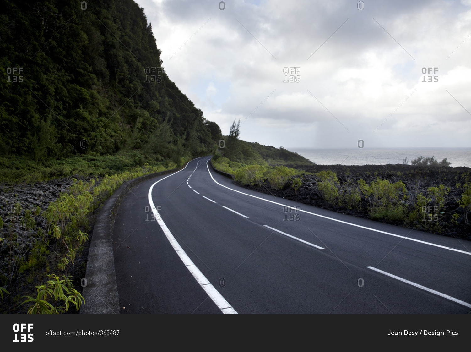Seafront road under a dramatic sky; Reunion Island, France