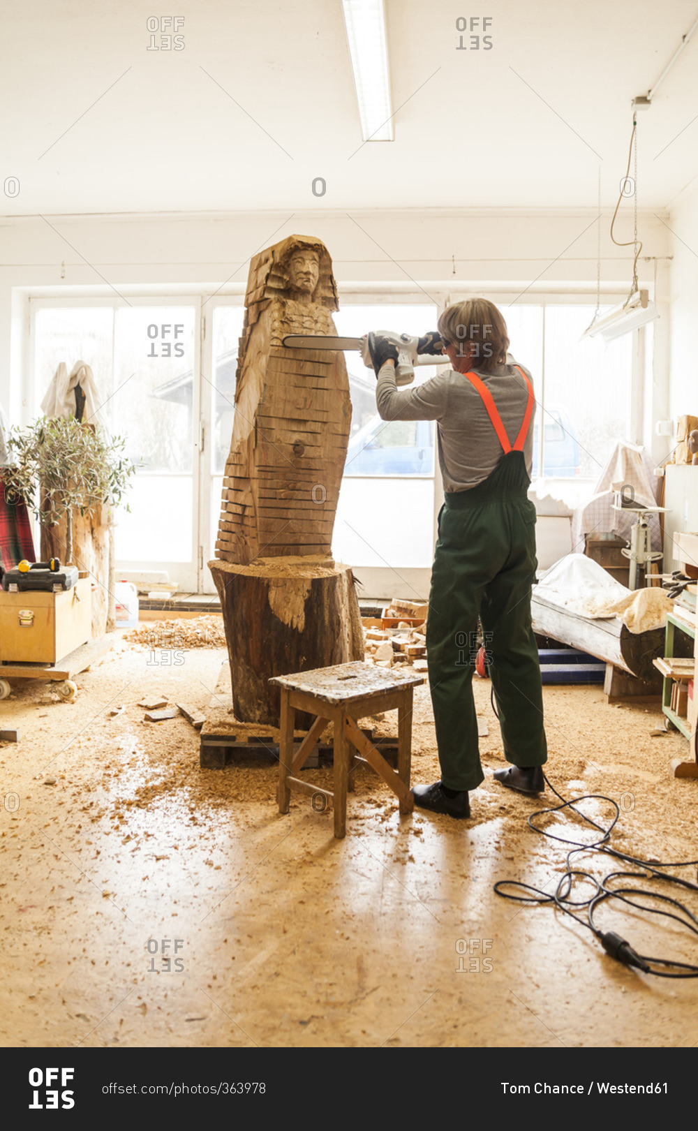 Wood carver working on chainsaw sculpture