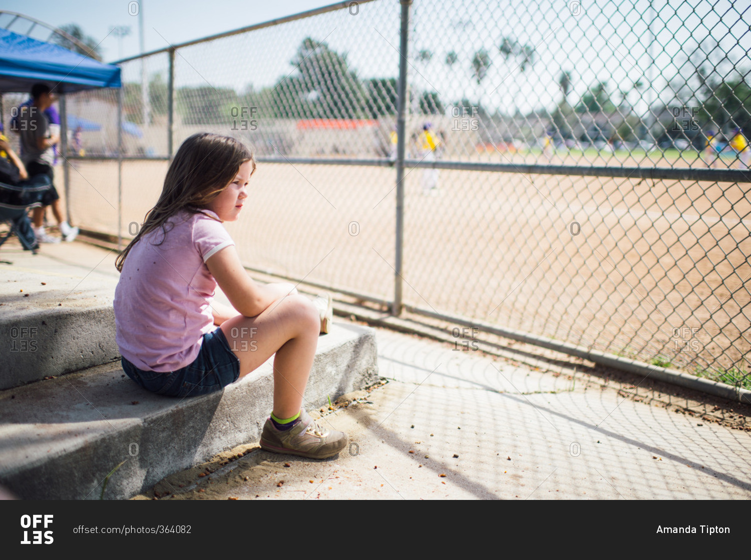 Girl watching a baseball game
