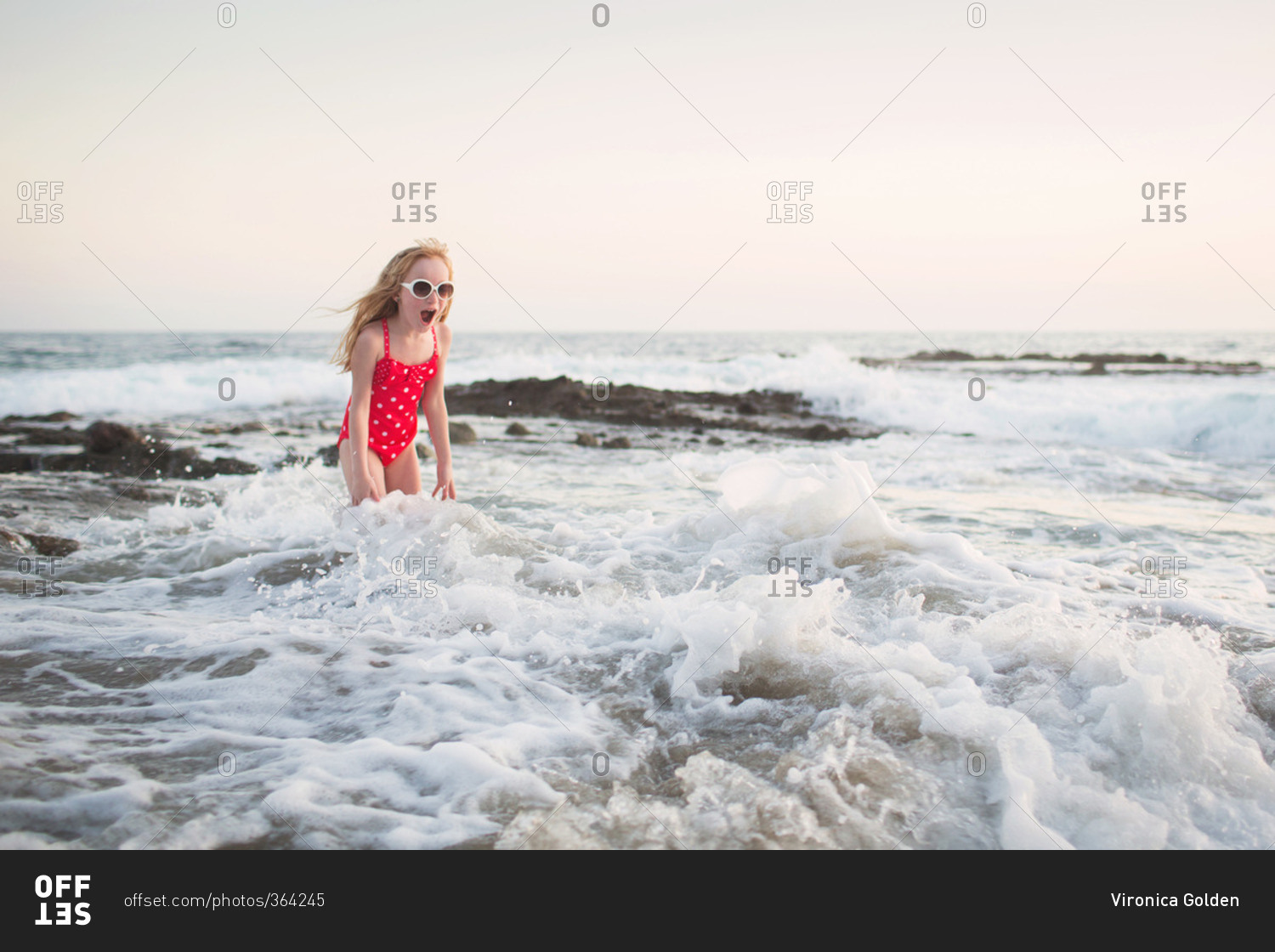 Girl surprised by ocean waves