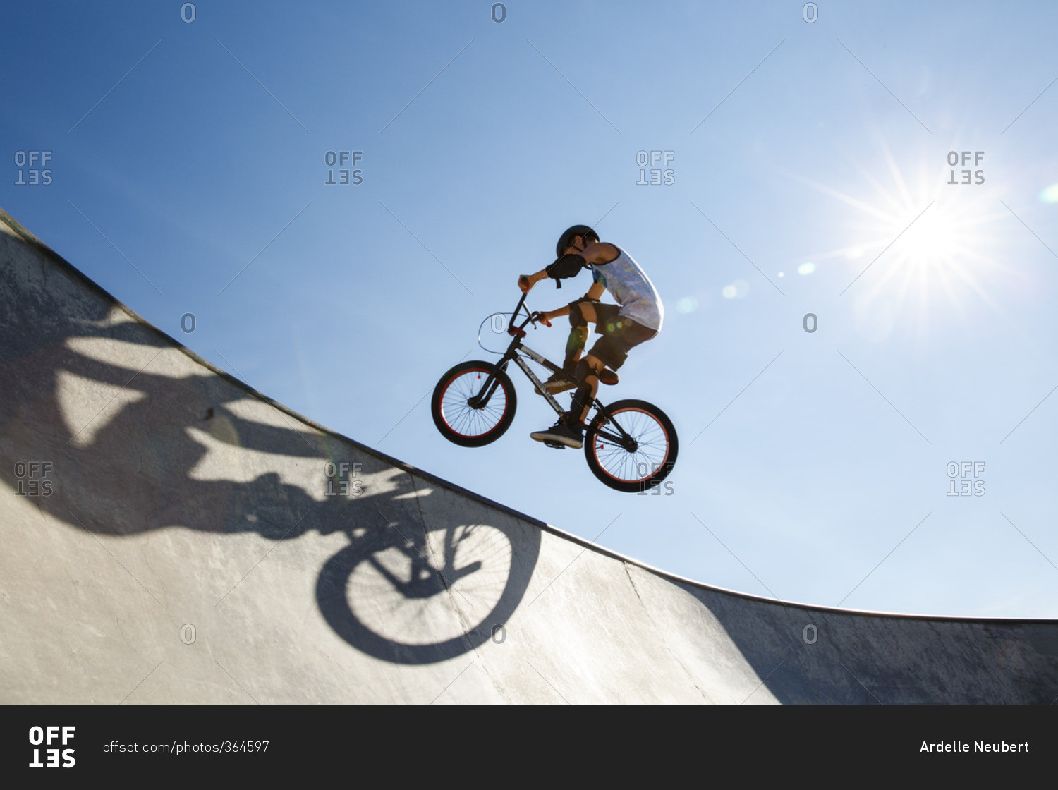 A young boy in mid-air doing a stunt on a bike