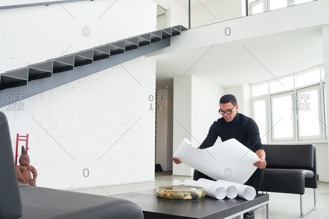 Man looking at blueprints