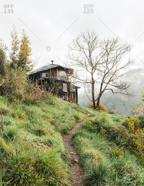 A wood house along a wooded hillside in Matavenero, Spain