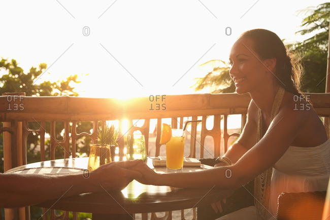 Couple holding hands on patio