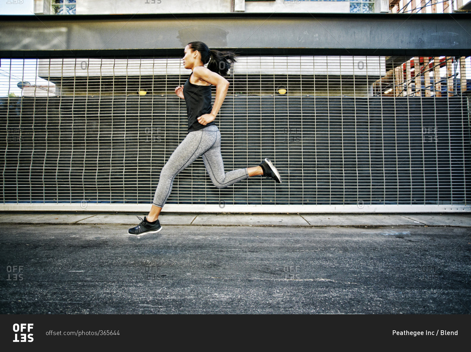 Mixed race athlete running on street