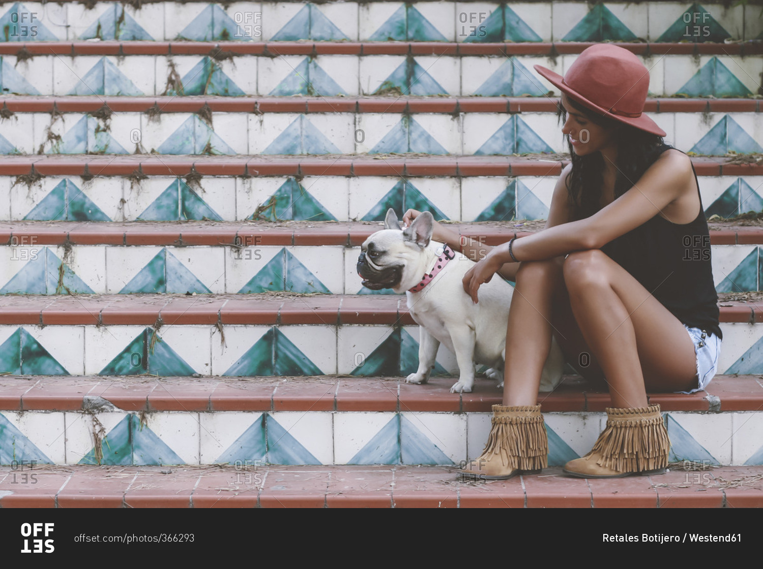 Woman sitting with her dog on stairs