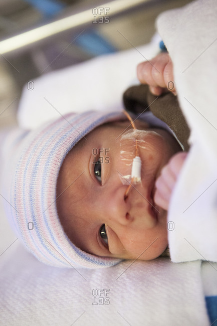 Premature newborn baby with nasal tube in hospital