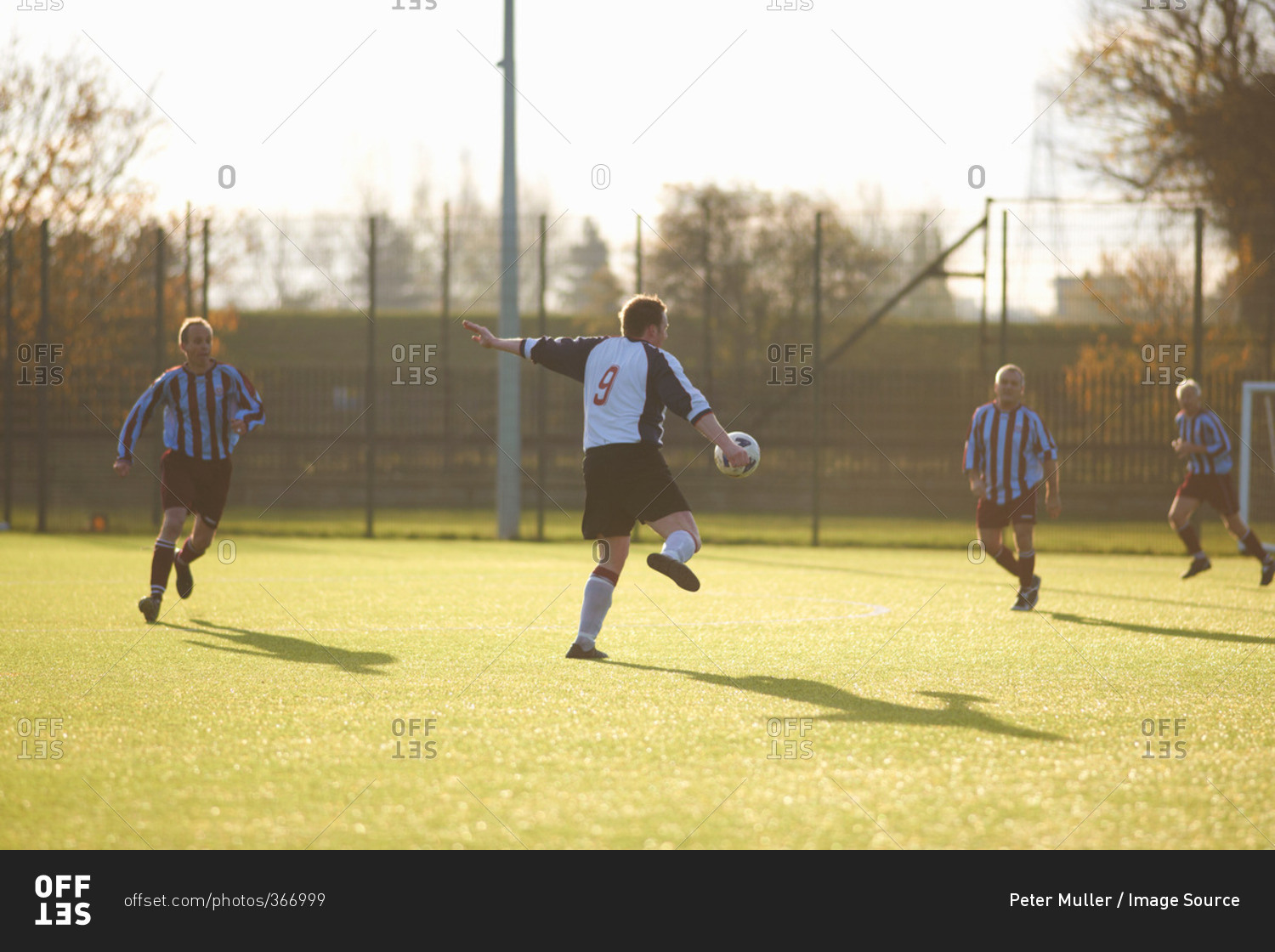 Soccer player kicking a high ball