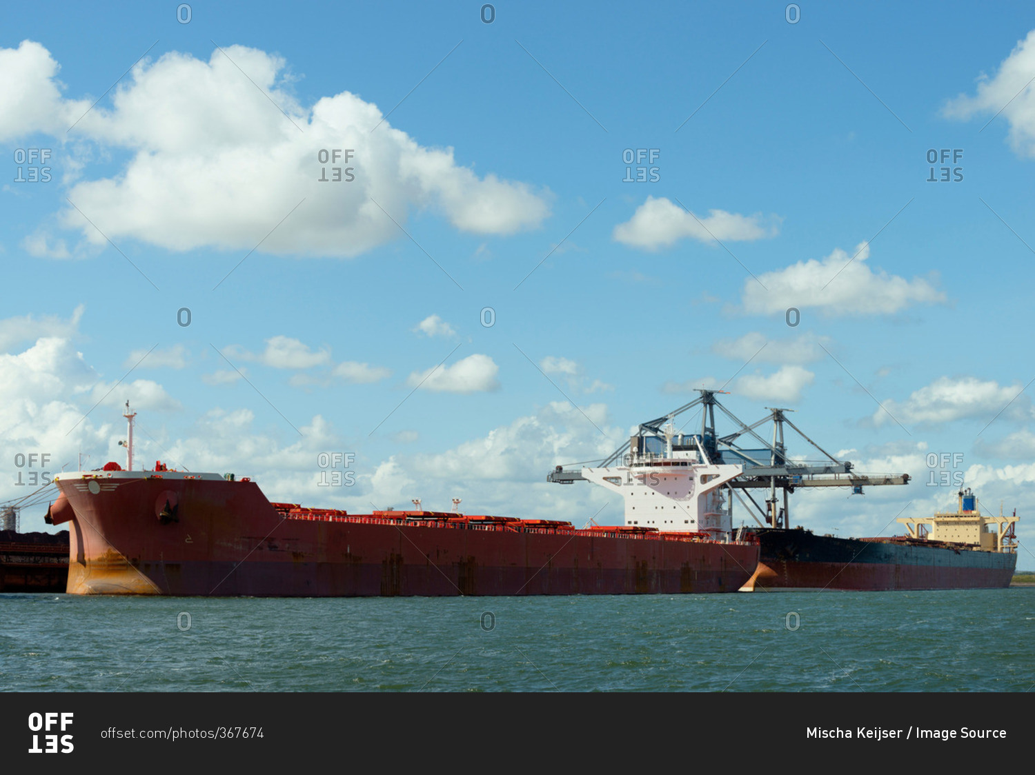 Huge ships moored in the Rotterdam harbor, used for transporting coal and iron ore