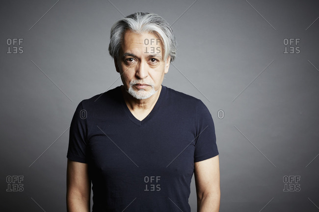 Portrait of a middle-aged man on a gray seamless background