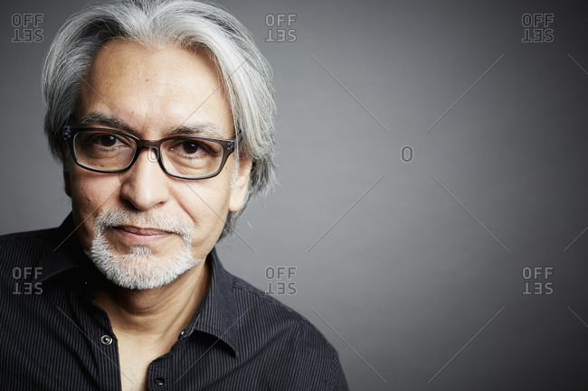 Portrait of a middle-aged man on a gray seamless background