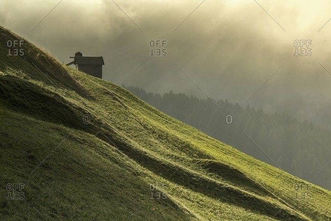 Dawn light rays on meadows of Sesto in Pustertal, sesto, Italy