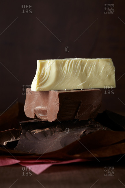 A stack of white, milk and dark chocolate chunks