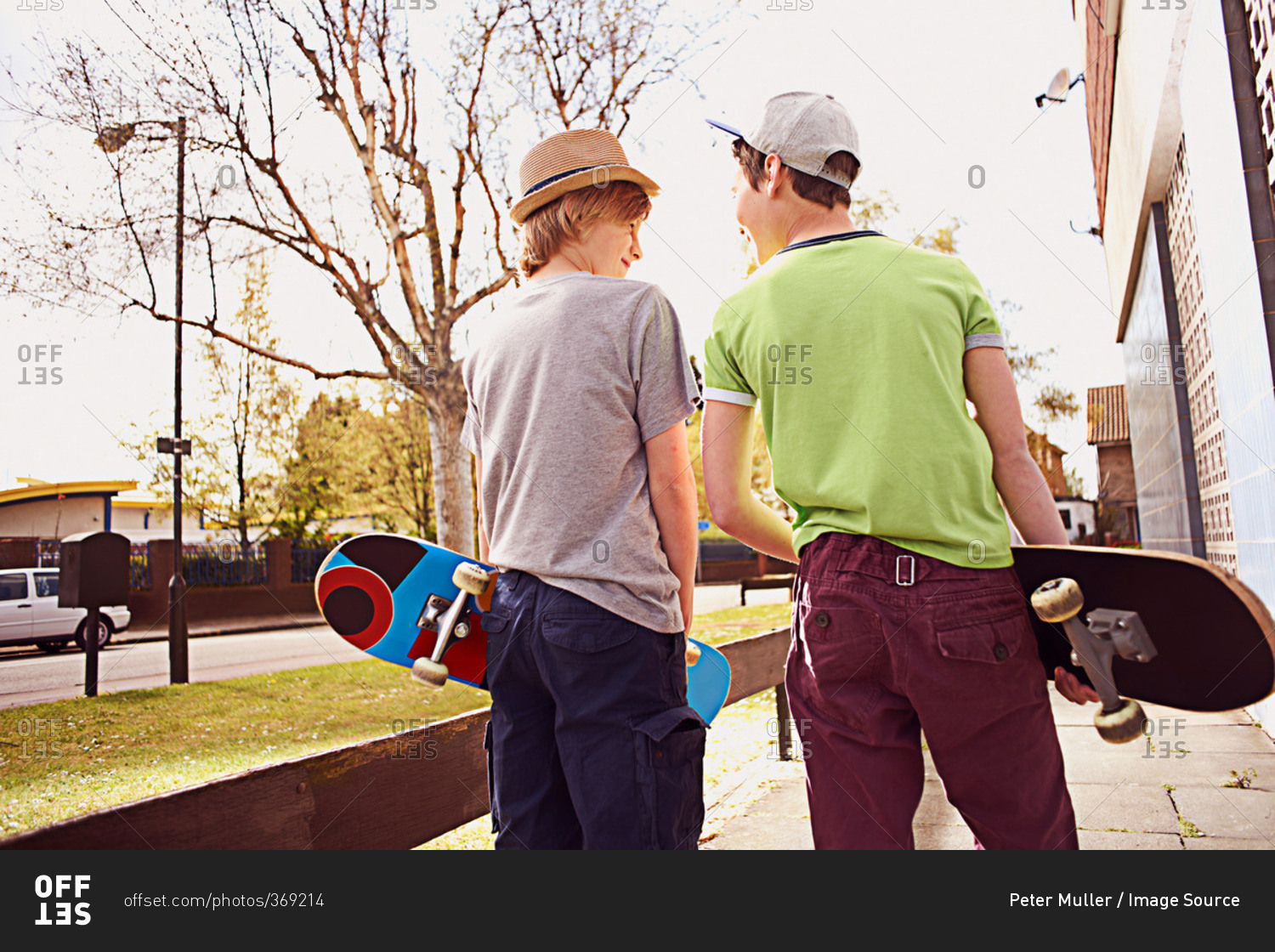 Boys carrying  skateboards