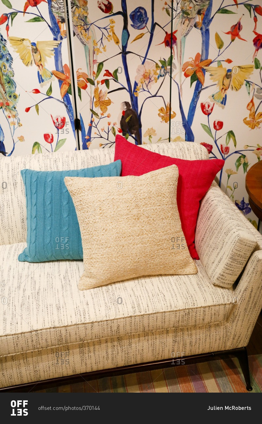 Sofa in a living room with colorful wallpaper
