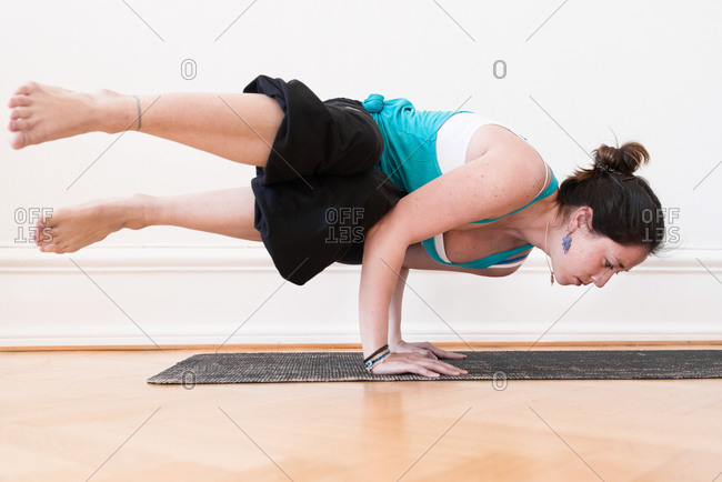 Woman in an advanced horizontal handstand yoga pose