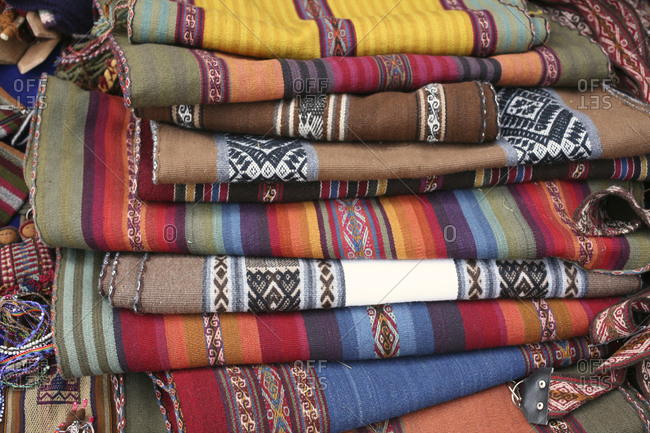 Stack of Andean rugs for sale in the Chinchero community, Cusco, Peru