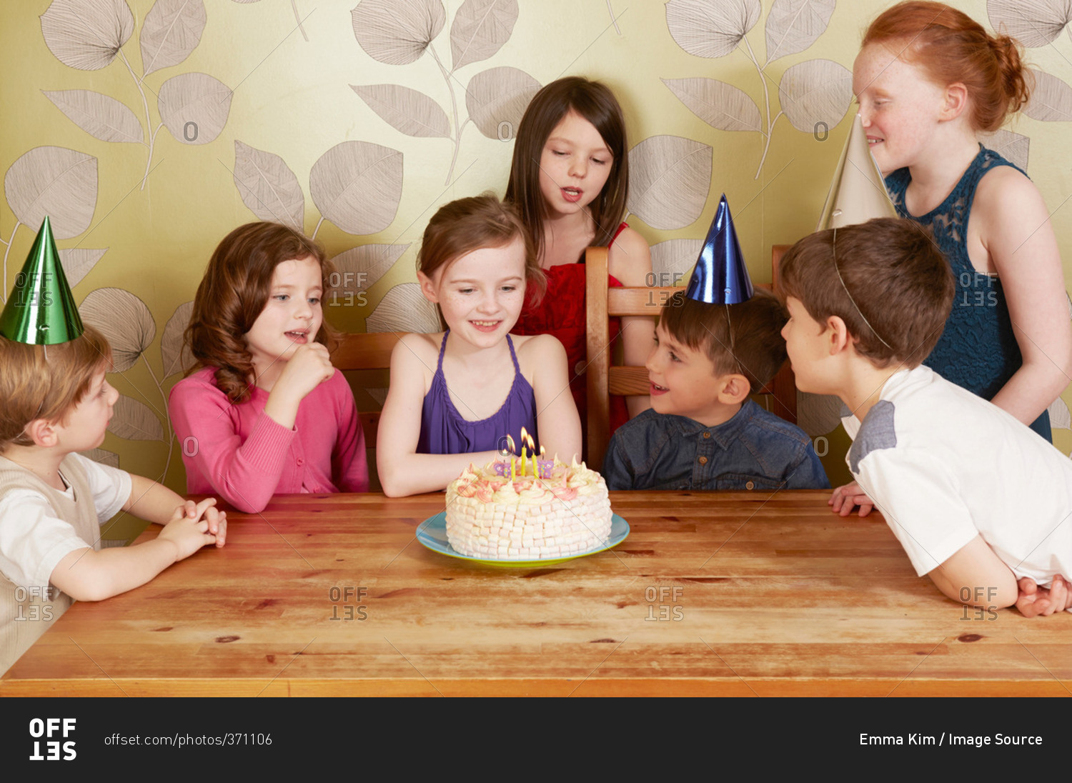 Children at birthday party, girl with cake