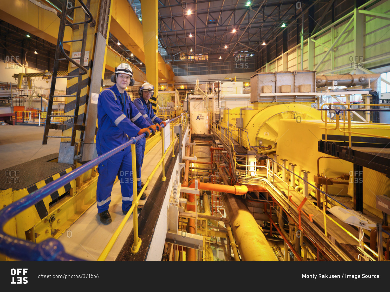 Portrait of workers in turbine hall of power station
