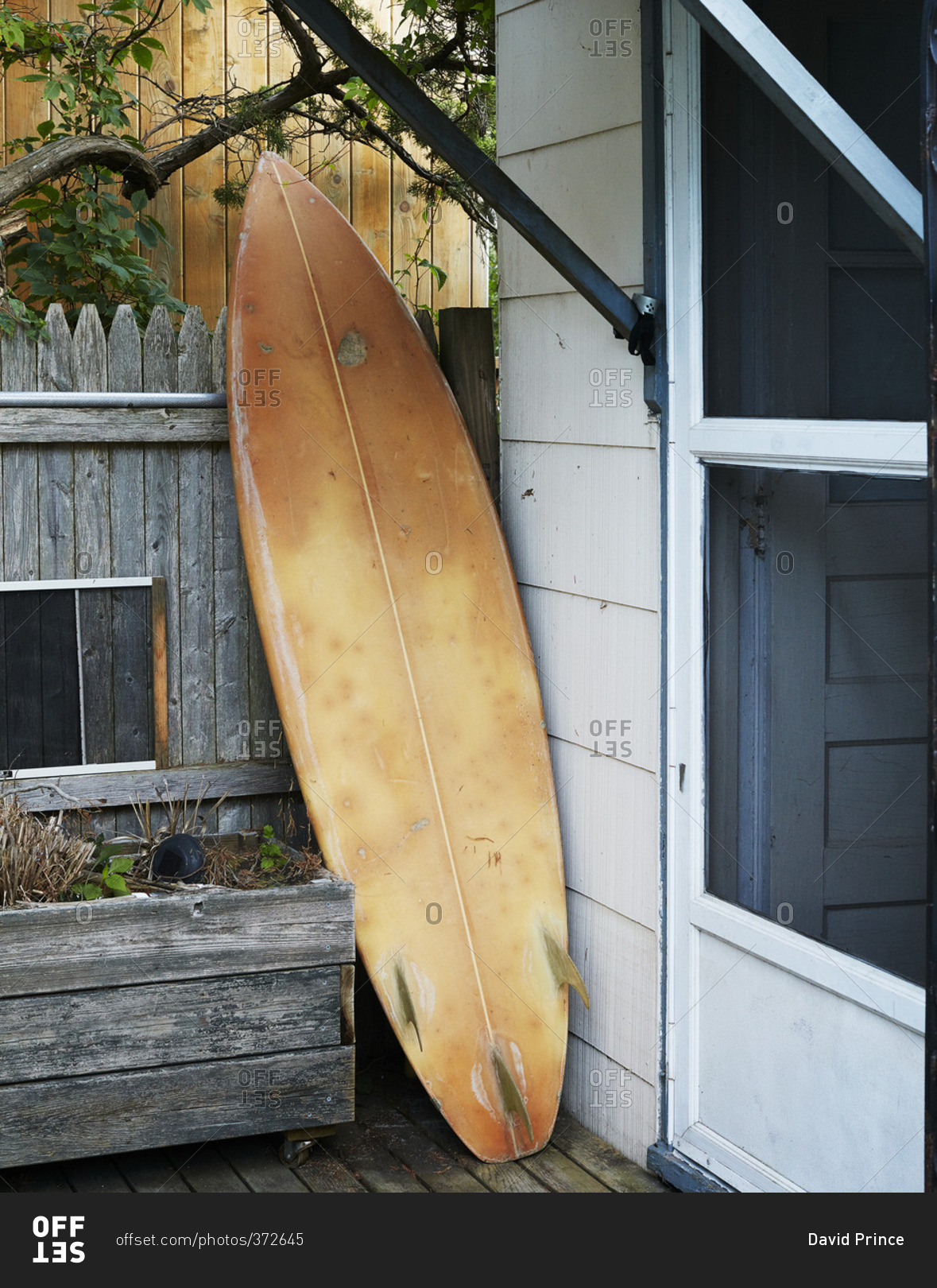Surfboard propped on deck