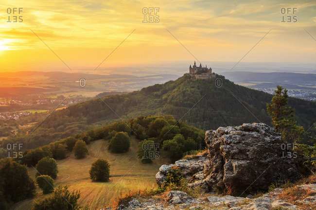 A castle on top of a hill at sunset
