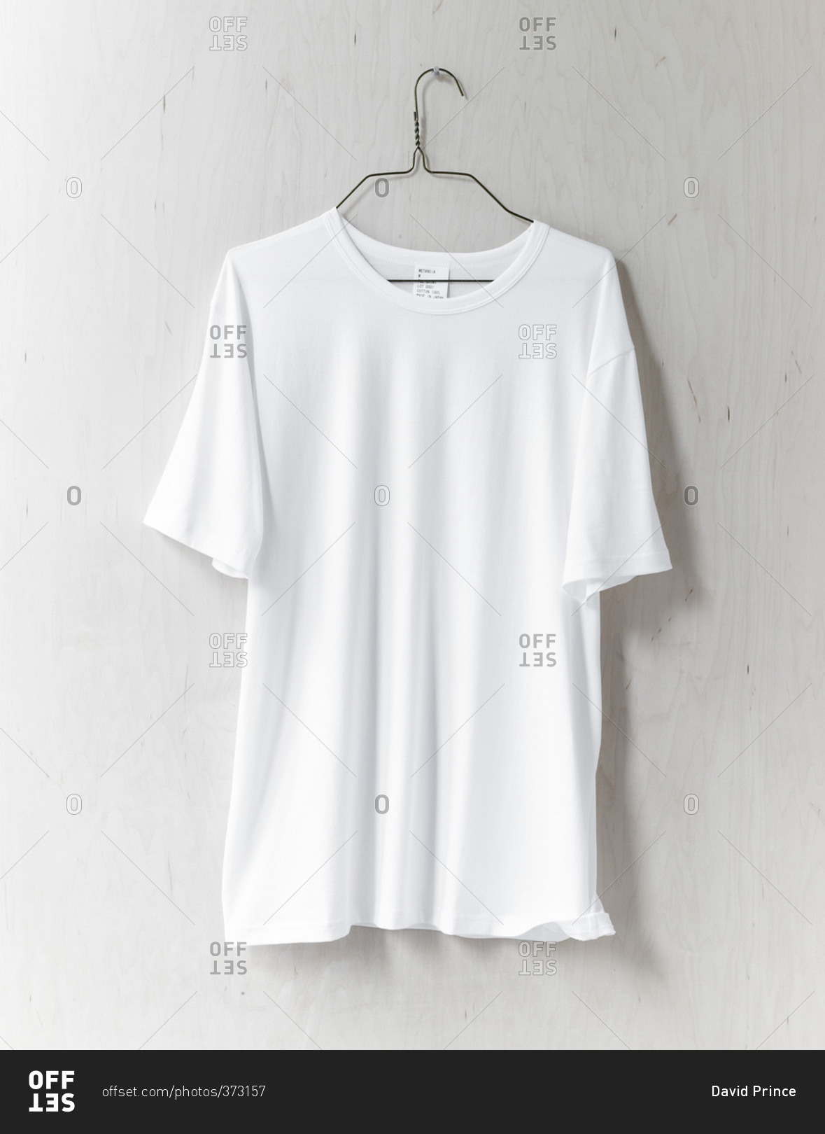 Download White T-shirt hanging on wall stock photo - OFFSET