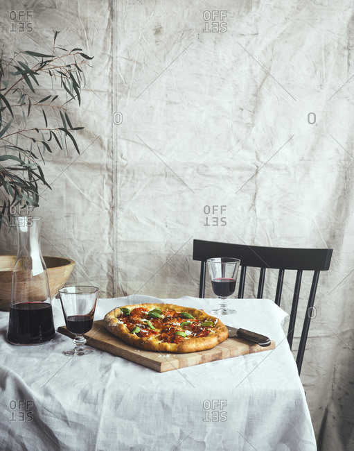 Table for two with homemade pizza and red wine