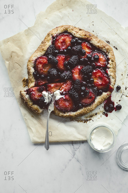 Rustic homemade berry tart on parchment paper