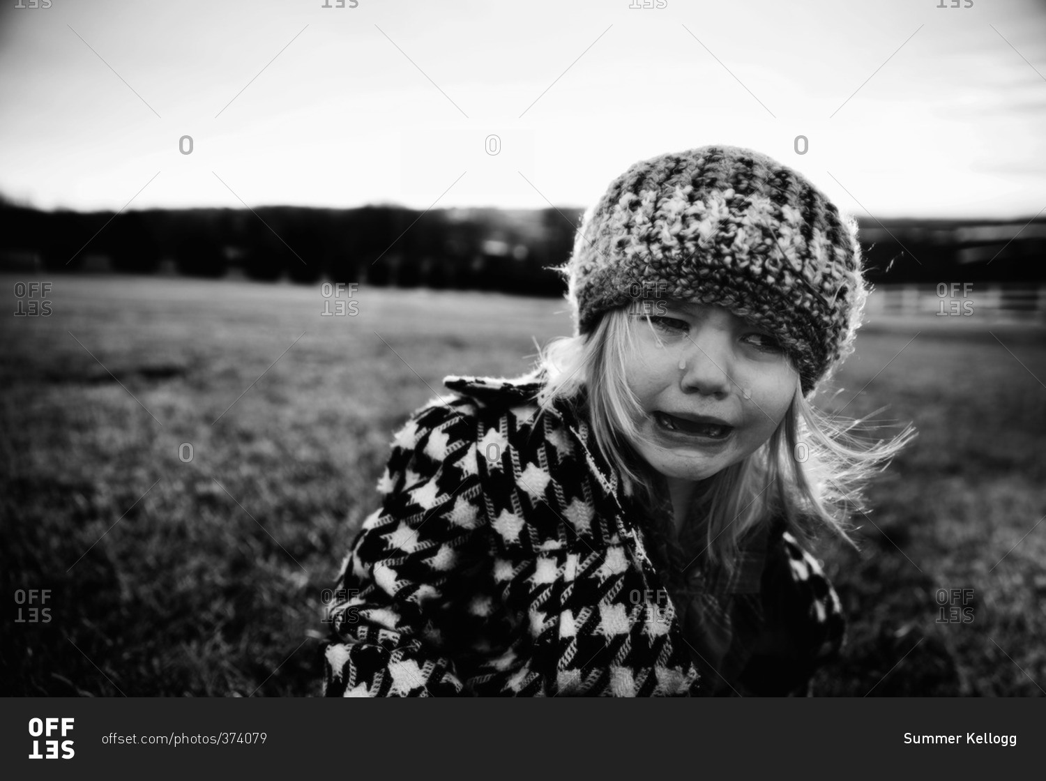 Black and white portrait of a little girl crying