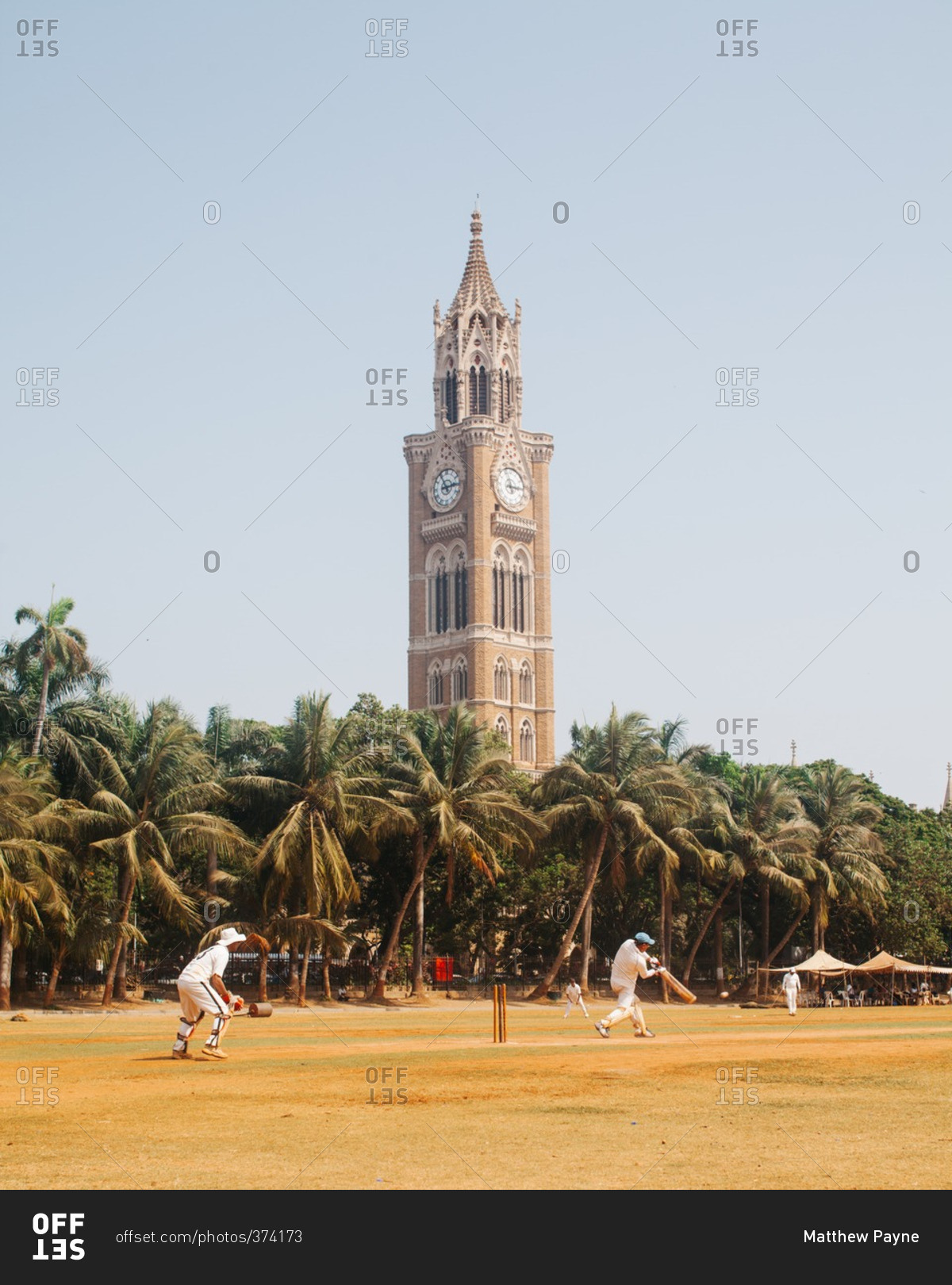 Cricket match near a clock tower
