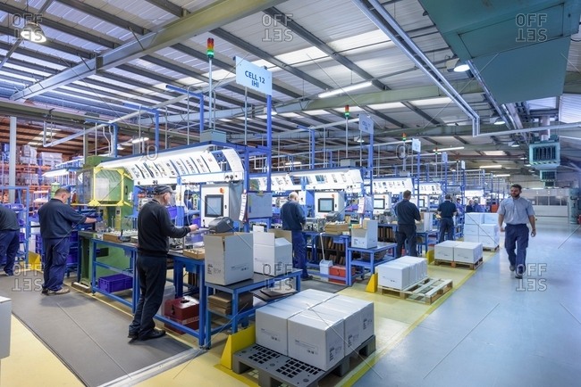 Workers on automotive parts production line in automotive parts factory