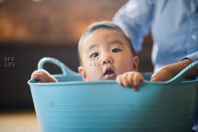 Baby boy sitting inside tub