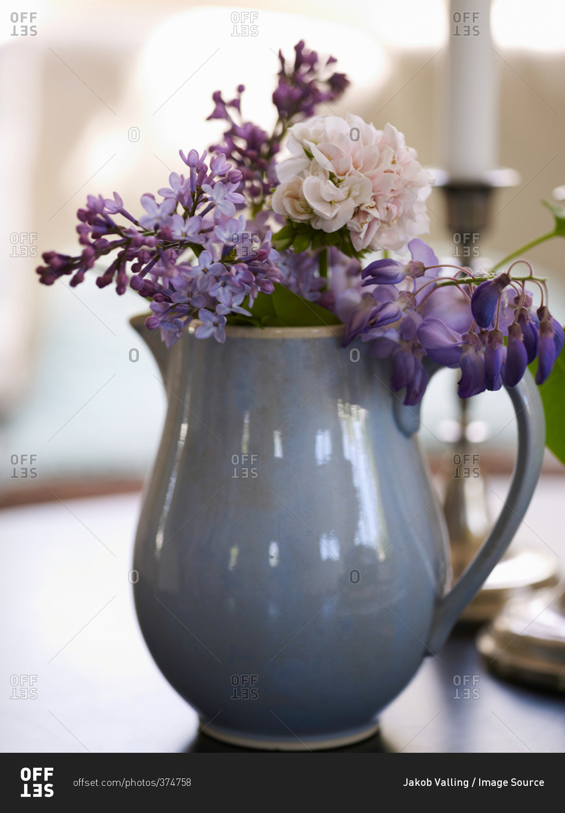 Vase of purple flowers on table