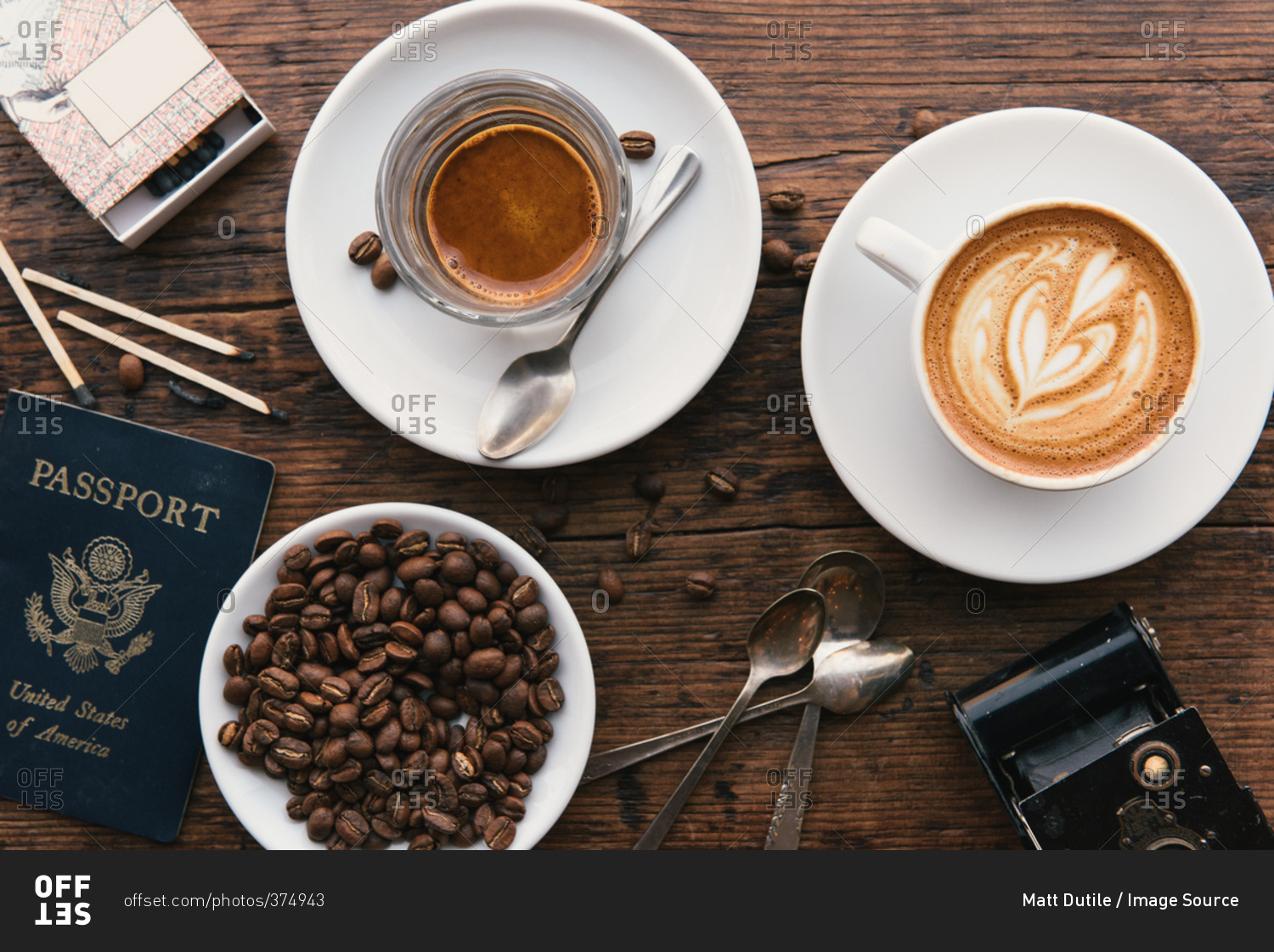 Overhead view of coffee's, coffee beans and American passport on coffee shop table