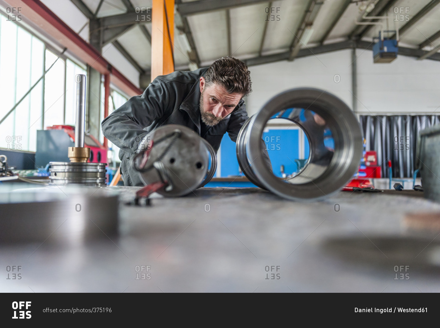 Man in front of hydraulic cylinder