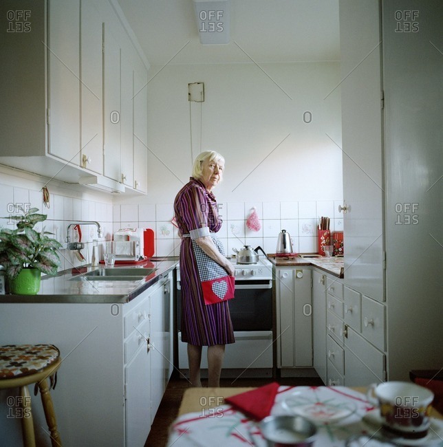 A elderly woman in a kitchen