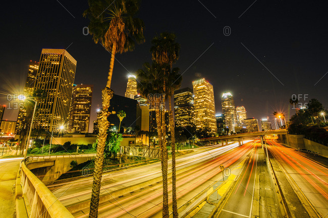 View of city skyline and highway at night, Los Angeles, California, USA