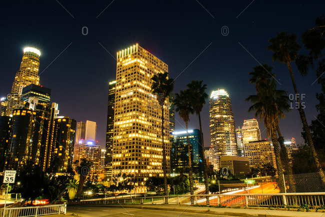 View of highway and city skyline at night, Los Angeles, California, USA
