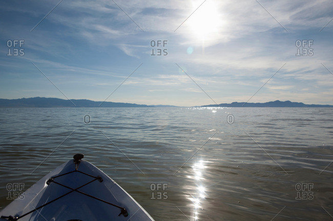 Bow of kayak with sunlight reflecting on water, Great Salt Lake, Utah, USA