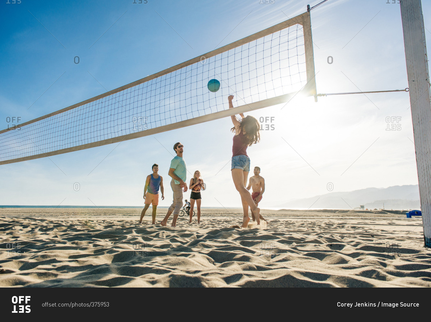 Group of friends playing volleyball on beach