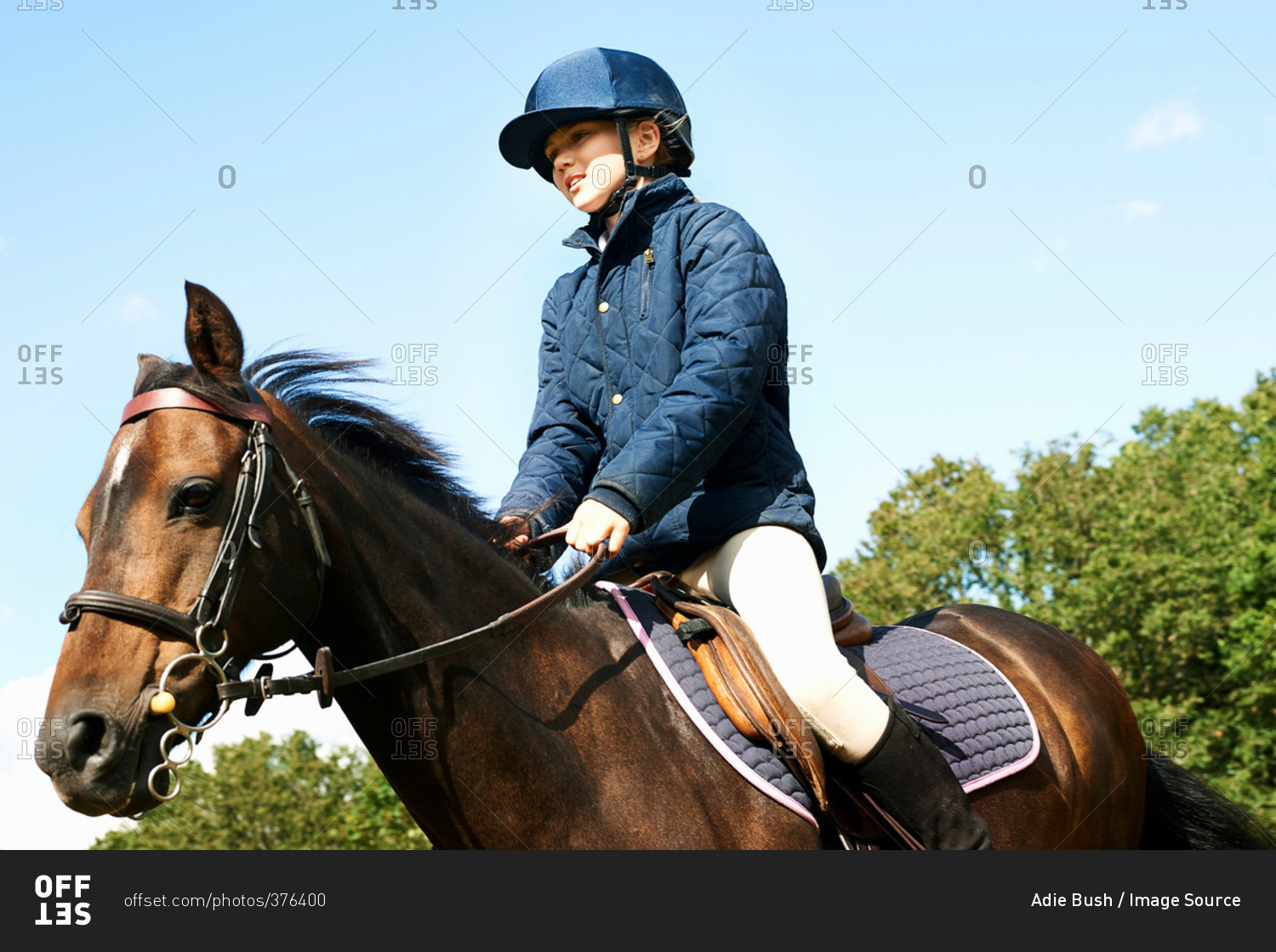 Girl riding horse in countryside