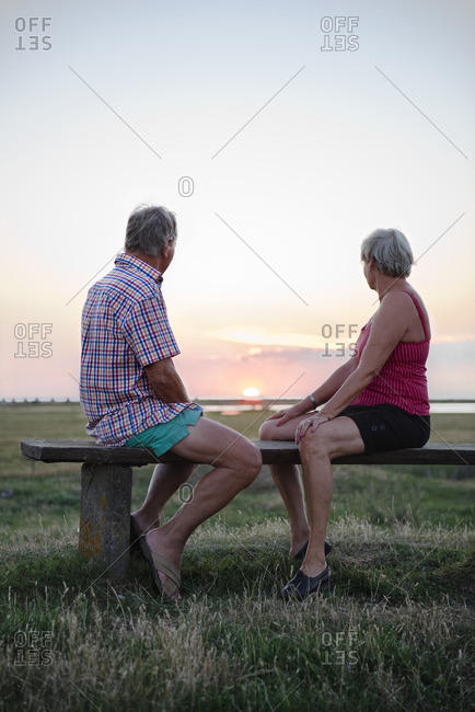 Senior couple looking at sunset