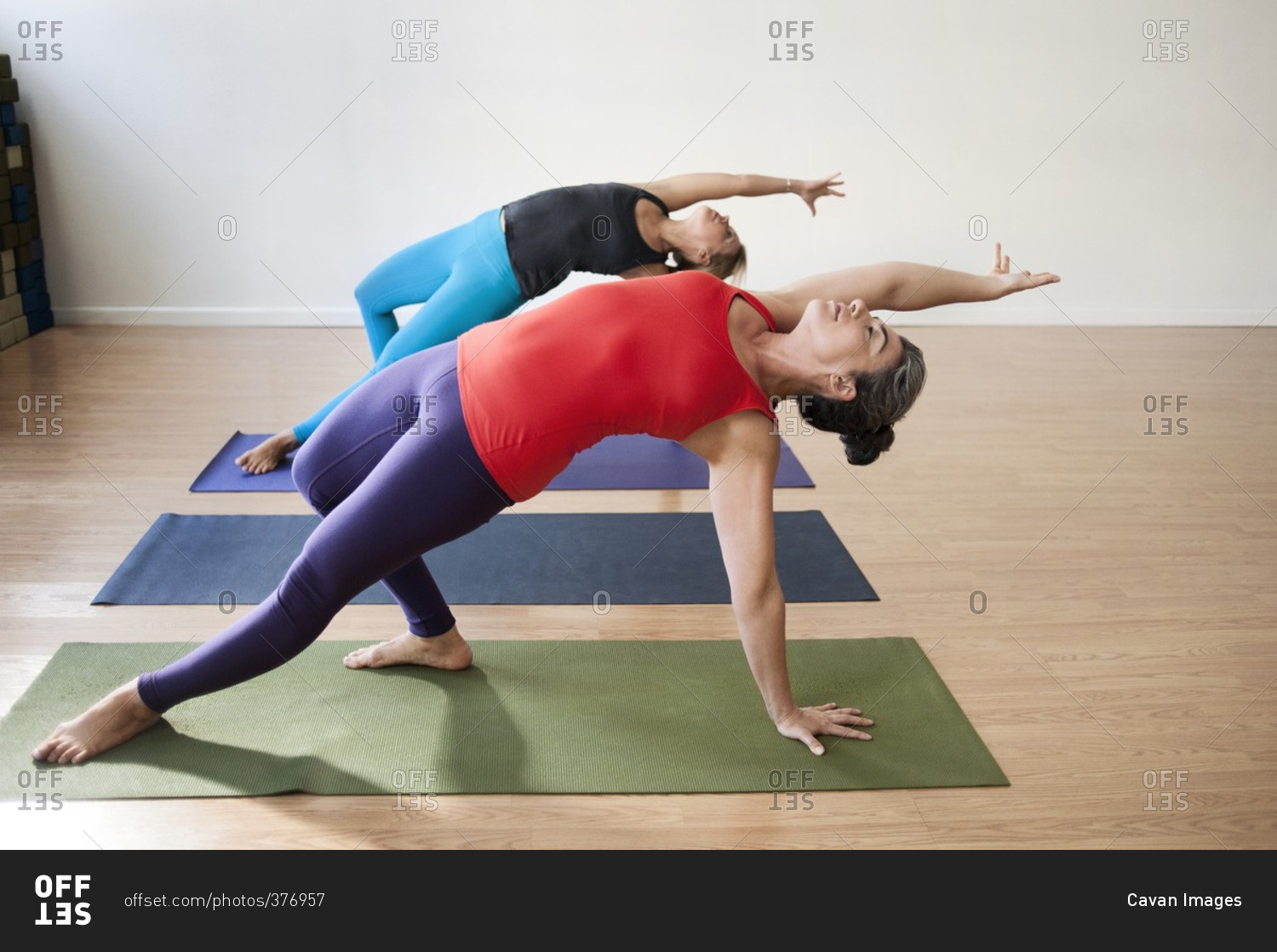 Women doing balance yoga exercise in health club
