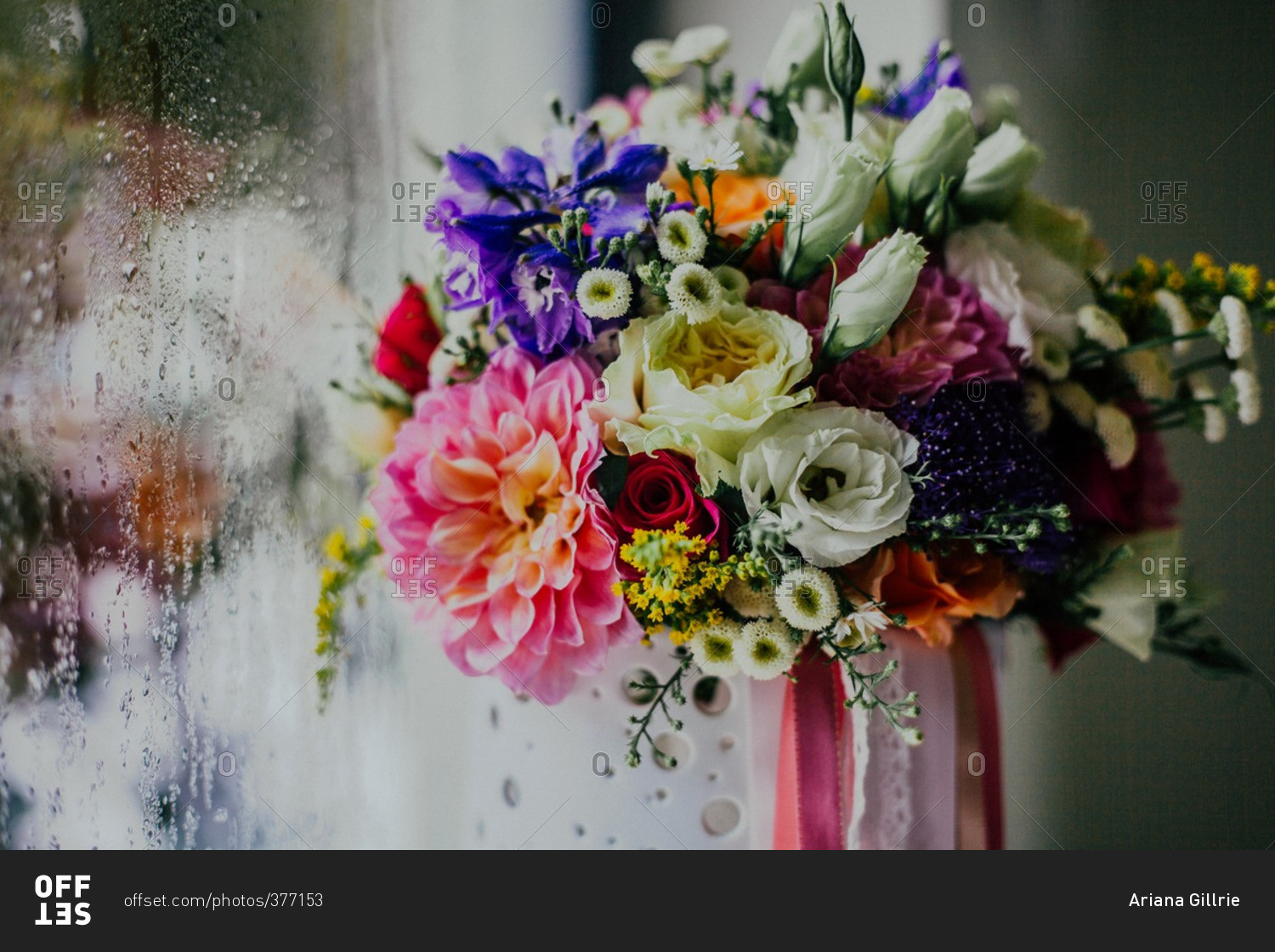 Bouquet of flowers against a window covered in condensation