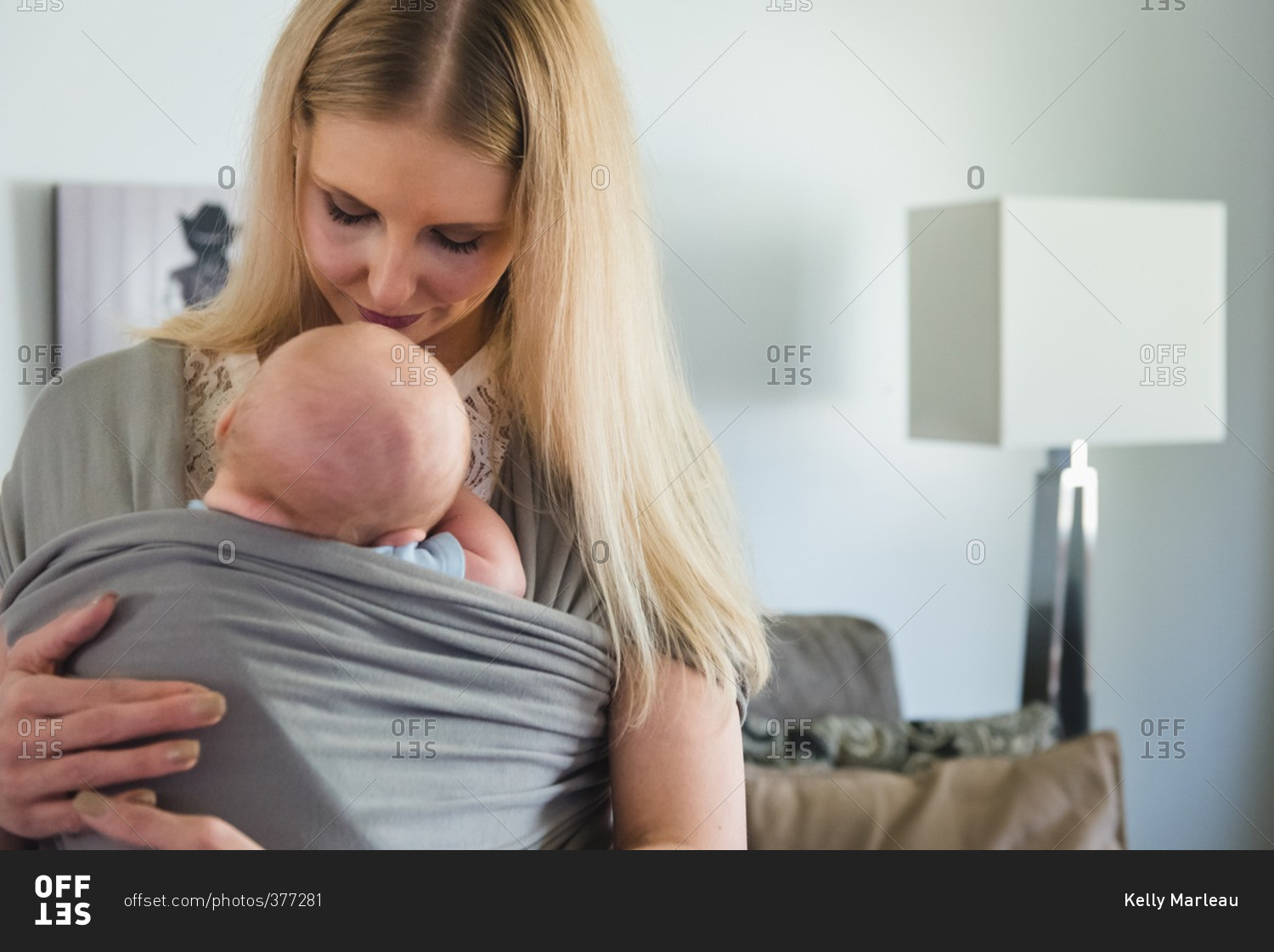 Mother holding her baby in a cloth wrap sling