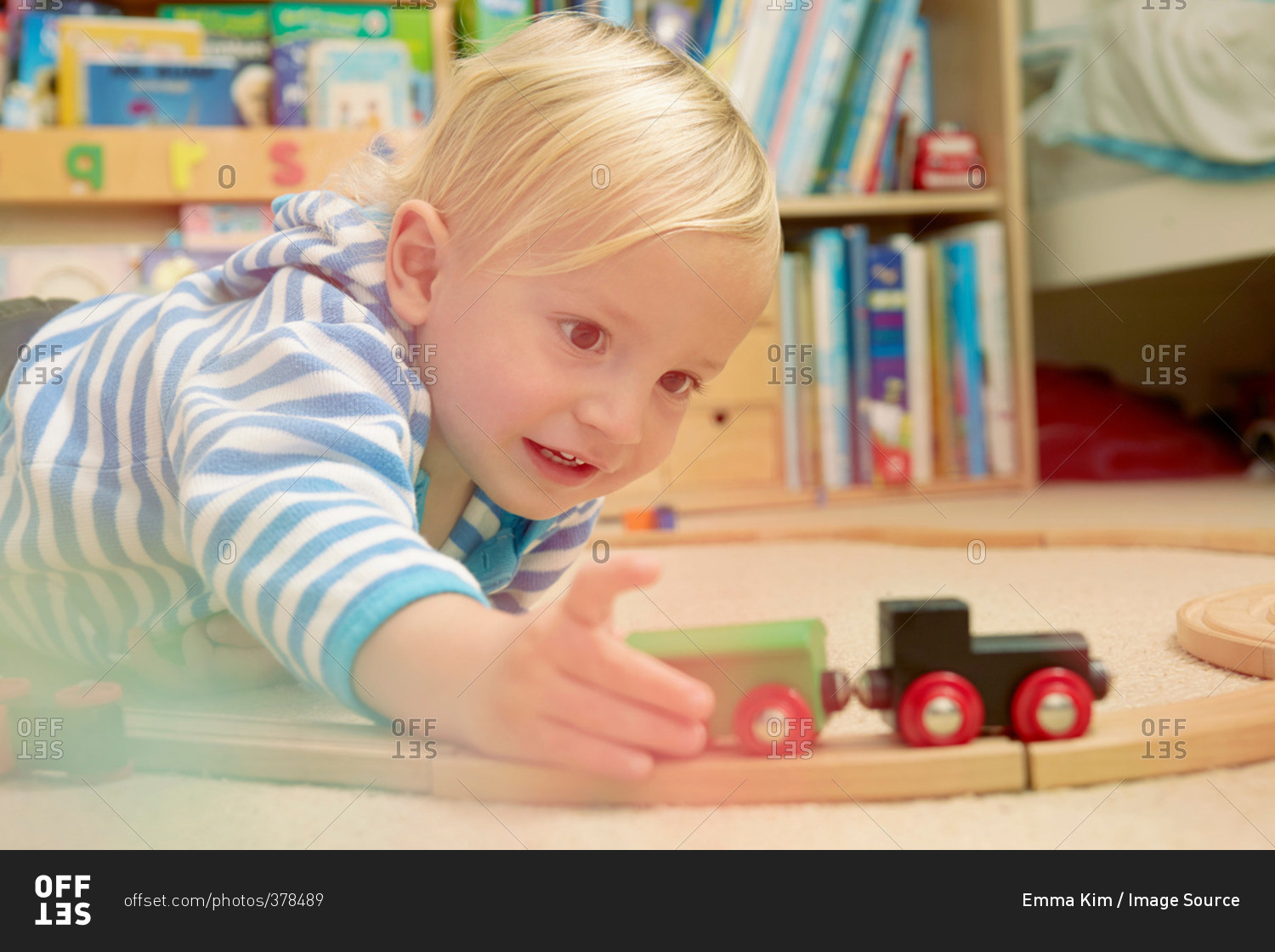 Baby boy playing with train set