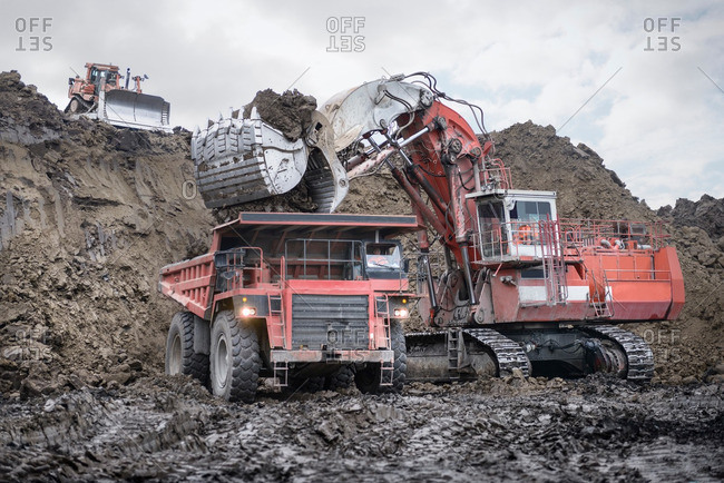 Large excavator and dumper truck in surface coal mine